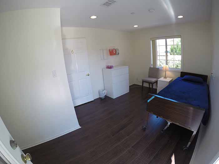 Furnished room at All Care Living Home